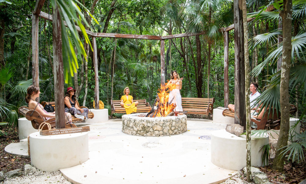 People gathered around a fire at Holistika